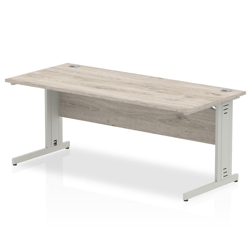 Dynamic Office Solutions Impulse 1800mm beech desk with silver cantilever legs and cable management features.
