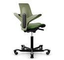 Green moss saddle chair with ergonomic design and silver aluminum base by HAG, featuring adjustable gas lift and footrest op