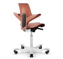 Ergonomic HAG Capisco Puls 8020 saddle chair in rosehip, featuring a silver aluminum base and customizable footrest options