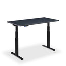 Height adjustable Lavoro Flyga desk with solid black top and sleek black frame.