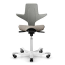 Clay ergonomic saddle chair with silver aluminium base, adjustable gas lift, and HAG branding.