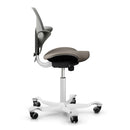 HAG Capisco Puls 8020 ergonomic saddle chair in clay color with silver aluminum base and adjustable gas lift.